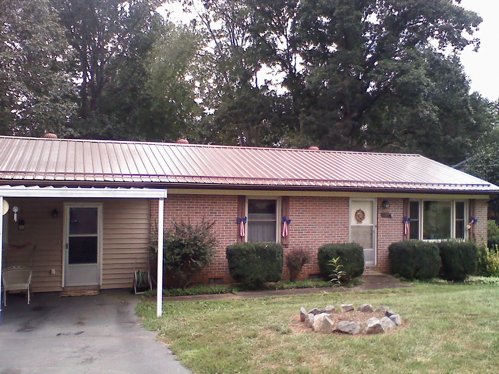 Bronze metal roof and carport on a brick ranch home — Roof Repair work by our crew in Park